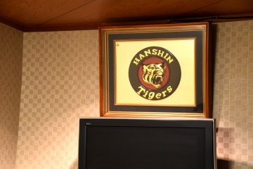 <p>Another Hanshin Tigers souvenir above the TV screen</p>