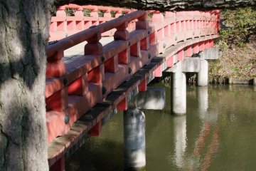 A red Japanese bridge inside the park