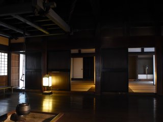 Spacious Japanese rooms with an irori fireplace in one of the thatched-roof houses