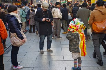 <p>A young boy wears a colorful lion costume and wins the hearts of many</p>