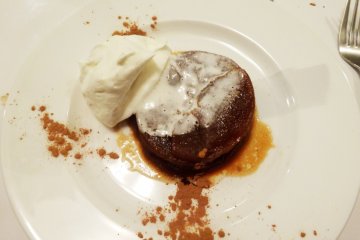 <p>A tarte tatin, or upside-down apple pie, served with fresh whipped cream</p>