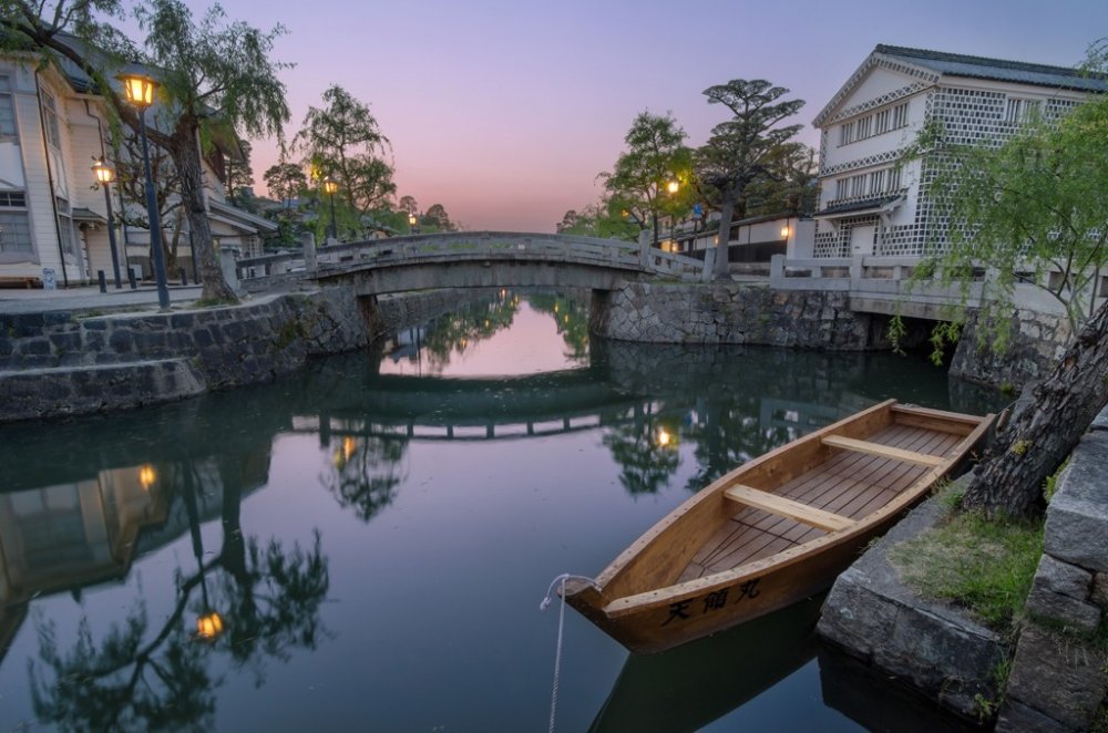 On a clear evening, colorful skies paint the streets and waters of the Kurashiki Bikan Historical Quarter with vivid, calming hues.