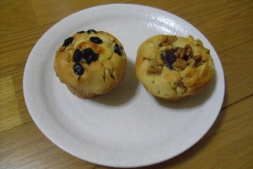 <p>A kinako, black bean and cream cheese muffin, and an anko (red bean jam) and walnut muffin</p>
