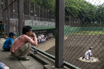 <p>This father watches his son intently... I think his son was the star catcher.</p>