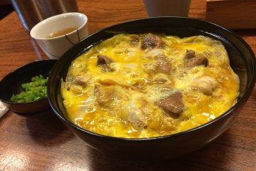 <p>The oyakodon inside the bowl! The egg is timed to gooey perfection, and the shamo is as generous as it is delicious. Simply amazing!</p>