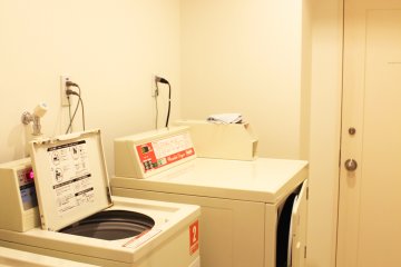 <p>The laundry room has two washing machines and a dryer.</p>