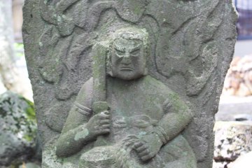 <p>A tombstone, or perhaps the depiction of a deity</p>