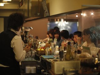 Customers ordering at the bar.&nbsp;