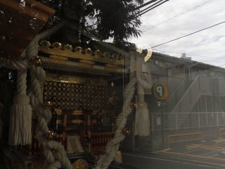 The window of the shrine reflects the modern street at Mitake shrine.&nbsp;