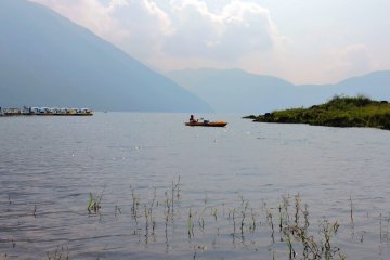 <p>The lake is surrounded by mountains</p>
