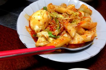 <p>A dish of Dokbokki to complete the meal. Dokbokki is a concoction of cylindrical-shaped Korean-style mochi mixed with vegetables in a richly flavored sweet and spicy sauce.</p>