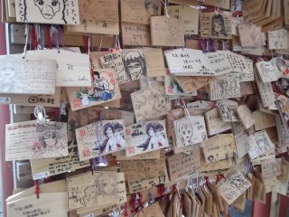 The closeness to Akihabara might explain all the manga-style prayer boards