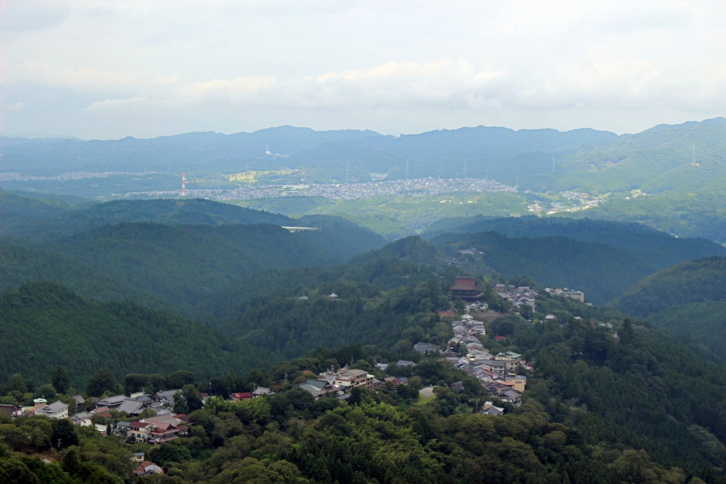 Kinpusenji Temple towers over all of the Town of Yoshinoyama and appears to stop the towns down hill flow against the backdrop of Oyodo Town and the other mountains of Nara
