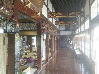 The corridor outside the main hall is beautifully decorate with plenty of carvings and polished wood floors.