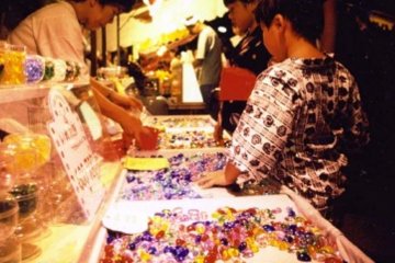 Young Yukata clad boy lost in a candy hued store