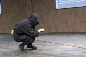 The instructor demonstrates how to walk stealthily and silently.