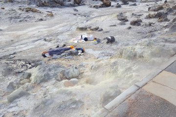 lying on the hokutolite rocks -   Tamagawa Onsen’s rocks with radium is a treatment for cancer patients