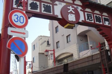 Come out Kawasaki Daishi Station and head straight down this street. You will eventually come to the temple walls on your right. Keep walking past them until you reach the end. Turn right at the intersection and right again onto the main street leading in