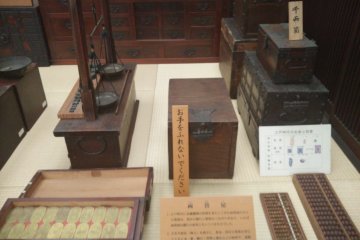 <p>Boxes used for storing money and a weight used to measure how heavy the money is</p>