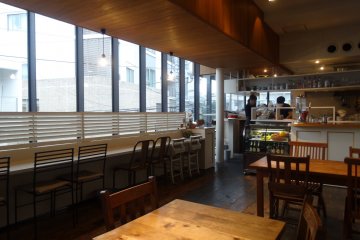 <p>The long counter near the front of the shop gives diners a view over the street below</p>
