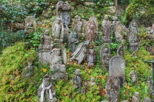 There are hundreds of small stone Buddhas along the hills . . .
