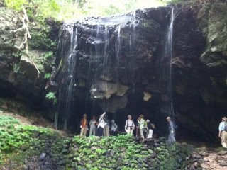 People gathered inside the waterfall