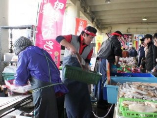 A fish merchant offers up the catch of the day
