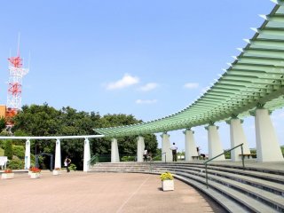 The artistically designed arc-shaped roof of the park's kiosk or relaxing shed