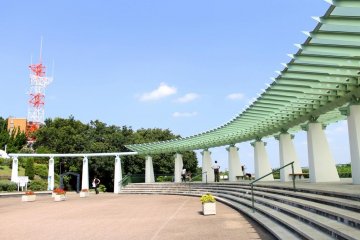 The artistically designed arc-shaped roof of the park's kiosk or relaxing shed