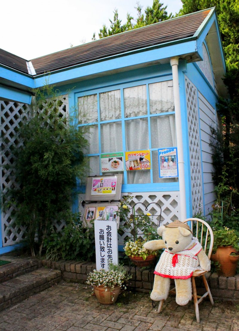 A cute little grandma bear guards the cottage by the rose garden