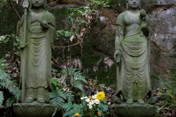 Buddha statues next to the waterfall