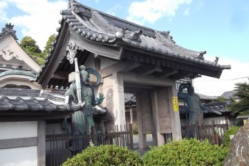 Two fierce statues stand guard at the gate