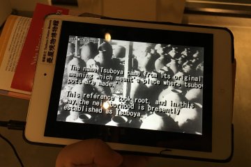 The tablet provides audio-visual information about the museum and its artifacts.