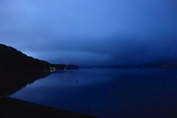 Darkest before dawn, a blanket of clouds hangs low over the lake at around 4:00 am