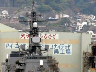 As you steam into Kure Port, you can see Mangan-ji Temple beyond the warships