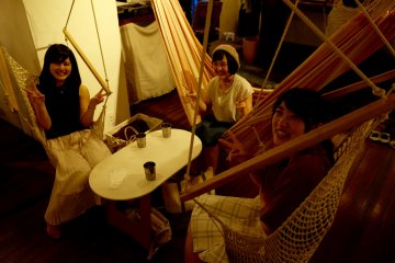 Friends enjoying their time in hammocks