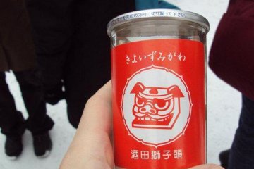 Local saké  is sold at the food stalls. Strong drinks help you forget how cold it is.