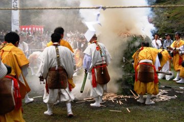 Once the bonfire is lit, yamabushi throw goma ki, wooden sticks containing peoples' wishes, into the fire