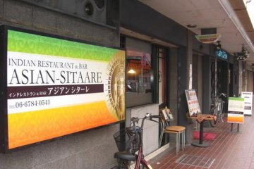 The shop in the Green White and Orange colors of the Indian Flag signal the start of your trip to Indian cuisine at  Asian Sitaare in Kintetsu Fuse in Osaka
