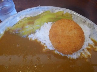 Curry & rice topped with eggplant and a creamy, crab croquette