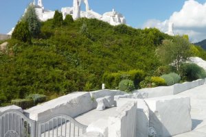 Bright blue sky, lush greenery and brilliant white marble of "The Heights of Eternal Hope for the Future" hill at Kosanji Temple