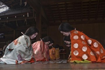 These ladies in court costumes playing karuta which is an ancient card game which have to match two halves of a poem
