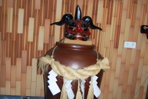 A shimenawa, a sacred Shinto rope, around this large vessel makes it a holy item.