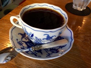 Drink your coffee from a Bohemian Zwiebelmuster (Blue Onion) porcelain cup and saucer