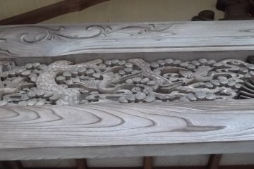 One of the sumptuous carvings under the eaves of the main hall