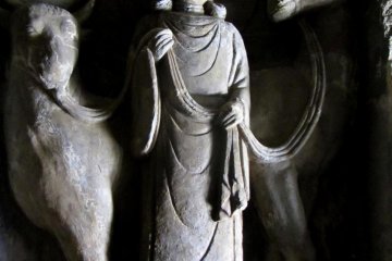 There are many statues carved into the cave walls