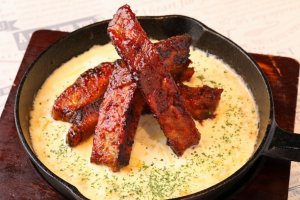 Spare ribs in a grilled cheese fondue