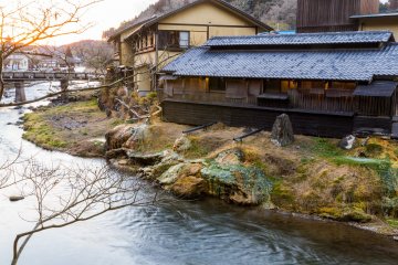 Daimaru Ryokan, with overflow pipes depositing colorful minerals on the riverbank