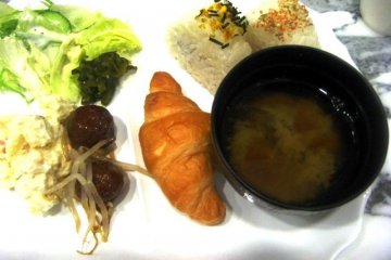 Complementary Breakfast with croissants potato salad onegiri and miso soup is served at the Toyoko Inn Nihonbashi