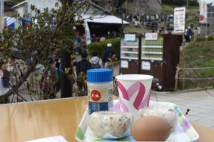 A cup of amazake, rice balls, and a piece of boiled egg for lunch